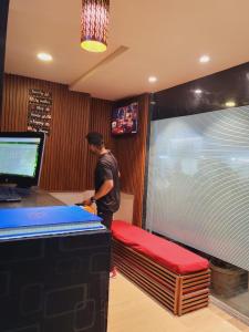a man standing at a counter in a store at Airport Inn Residency Mumbai in Mumbai
