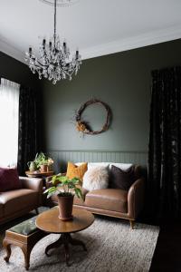 a living room with a couch and a table at Seapoint Cottage, Luxury Accommodation in Napier +8 photos