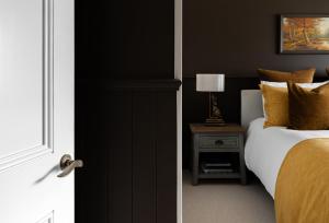 a bedroom with a bed and a table with a lamp at Seapoint Cottage, Luxury Accommodation in Napier