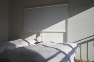 a bedroom with a bed and a large window at 果実の見える宿 in Koshu