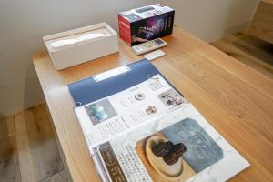 a magazine sitting on a table next to a box at 果実の見える宿 in Koshu