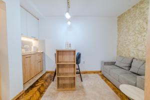 a living room with a couch and a table at Studio H&M in Užice