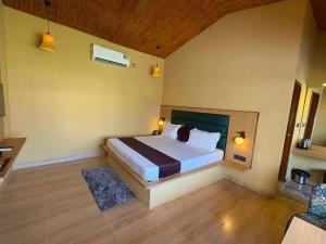a bedroom with a large bed in a room at Eeja Resto and Cafe in Garappu +12 photos