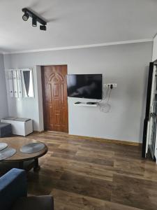 a living room with a flat screen tv on a wall at Noclegi w Dolinie Baryczy in Radziądz