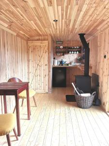 a kitchen with a woodburning stove in a room at Maringotka Rozálka in Dlouhá Stropnice
