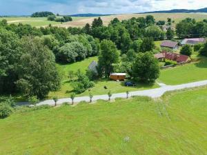 an overhead view of a field with a house and a road at Maringotka Rozálka in Dlouhá Stropnice