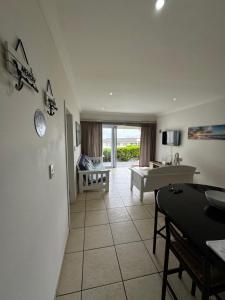 a large living room with a tub and a table at Mangrove Beach Estate Boboyi in Port Shepstone