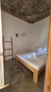 a bedroom with a bed in a room at Camotes Hostel Resort Fan Rooms in San Francisco