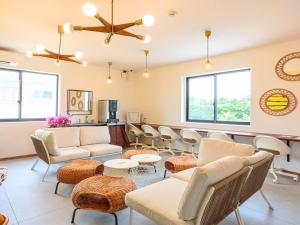 a waiting room with couches and chairs at ランズコンドホテル宮古島 in Miyakojima