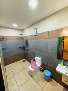 a bathroom with a pink toilet and a sink at Mountain View A frame Pool Villa in Meppādi +31 photos