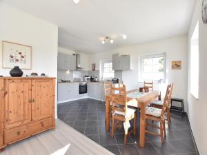 a kitchen and dining room with a table and chairs at Apartment, Oldenburg in Holstein in Oldenburg in Holstein