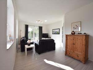 a living room with a couch and a table at Apartment, Oldenburg in Holstein in Oldenburg in Holstein