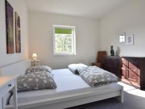 a bedroom with a bed with two pillows and a window at Apartment, Oldenburg in Holstein in Oldenburg in Holstein