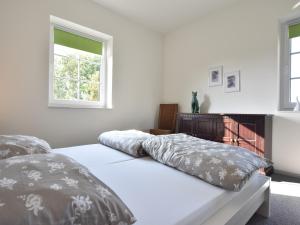 a white bedroom with two beds and a window at Apartment, Oldenburg in Holstein in Oldenburg in Holstein +84 photos