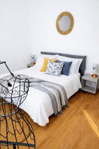 a bedroom with a bed and a mirror on the wall at VM Ravenna Luxury Apartment in Ravenna