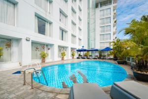a swimming pool in front of a building at Mondial Hotel Hue in Hue