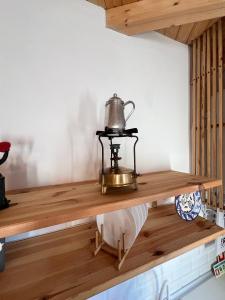 a tea kettle on a wooden shelf in a room at Casa do Mestre in Amieira