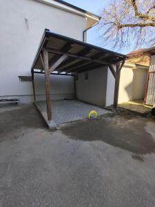 a garage with awning on the side of a building at Thaleia Retreat in Ocna-Mureşului
