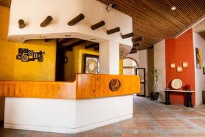 a lobby with a counter in the middle of a building at Marina Cabo Plaza Town & Beach Condos in Cabo San Lucas +152 photos