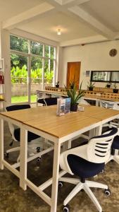 an office with a large wooden table and chairs at Camotes Hostel Resort Fan Rooms in San Francisco