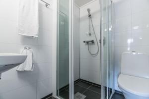 ein Badezimmer mit Dusche, Toilette und Waschbecken in der Unterkunft Almaas Hotell Stord AS in Stord