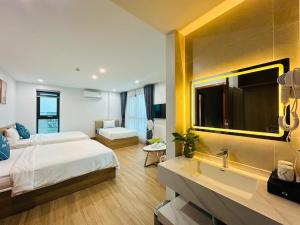 a bedroom with a bed and a sink and a mirror at Sky Hotel in Ninh Binh +48 photos