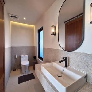 a bathroom with a sink and a mirror at Via Adonia Mezzanine in Ungasan