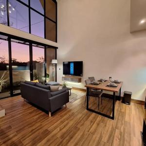 a living room with a couch and a table at Via Adonia Mezzanine in Ungasan