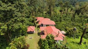 an overhead view of a group of houses with red roofs at Coffee County in Srimangala