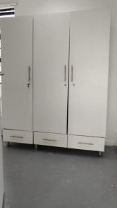 three white cabinets are lined up in a room at Halford Backpackers, Durban in Durban