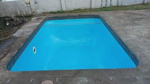 a blue swimming pool in a yard at Halford Backpackers, Durban in Durban