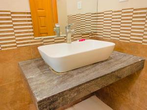 a white sink on a counter in a bathroom at Hazelton in Islamabad +52 photos
