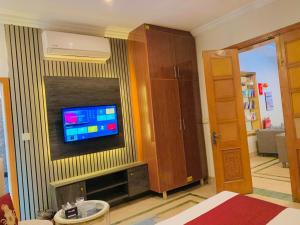 a living room with a television on a wall at Hazelton in Islamabad