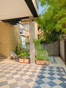 a courtyard with a bench and plants in a building at Hazelton in Islamabad