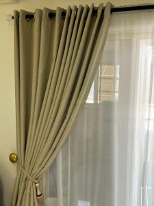 a curtain that is hanging in a window at ShowLove Luxury Apartment in Lekki Phase 1 +12 photos