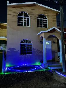 a house with blue and green lights in front of it at Bridgeview Arcadia Three in Portmore +27 photos