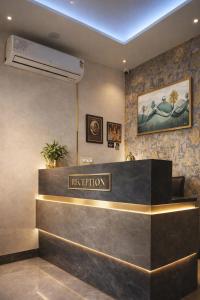 a reception desk in a hotel lobby at Hotel Alpine in Indore