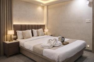 a hotel room with a bed with towels on it at Hotel Alpine in Indore
