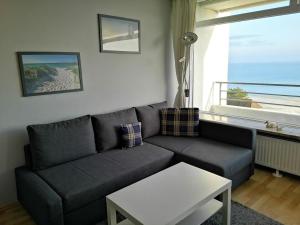 a living room with a couch and a table at Strandhotel Wohnung 69 in Dahme