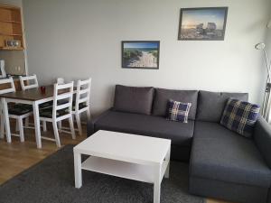 a living room with a couch and a table at Strandhotel Wohnung 69 in Dahme