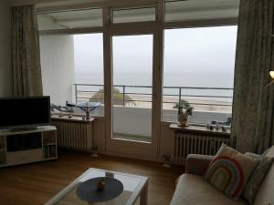 a living room with a view of the ocean at Strandhotel App. 63 in Dahme +6 photos