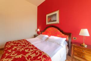 a red bedroom with a bed with a red wall at Hotel Isabella in Taormina