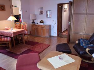 a living room with a couch and a table at Lindenhof Wohnung 19 in Dahme +6 photos