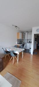 a living room with a table and a kitchen at Strandhotel Wohnung 24 in Dahme