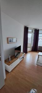 a living room with a flat screen tv on a table at Strandhotel Wohnung 24 in Dahme