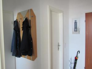 a mirror hanging on a wall next to a door at Strandhotel Wohnung 28 in Dahme