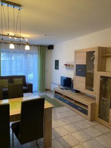 a living room with a dining table and a television at Saarstrasse 18h in Dahme