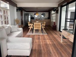 a living room with a white couch and a table at Bang Kao Beachfront Villa in Nathon Bay +5 photos