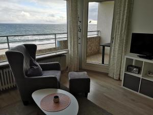a living room with a view of the ocean at Strandhotel Wohnung 68 in Dahme