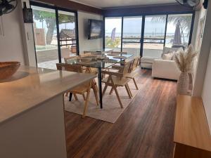 a kitchen and living room with a table and chairs at Bang Kao Beachfront Villa in Nathon Bay